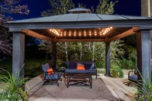 a gazebo with lights and chairs on a patio at Comfort Inn Fort Morgan in Fort Morgan