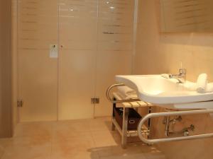 a bathroom with a sink and a shower at Palladio Hotel Buenos Aires - MGallery in Buenos Aires