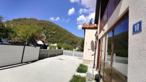 a house with a fence and a mountain in the background at Vila&Apartments Helena in Kolašin
