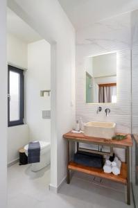 a white bathroom with a sink and a mirror at L'Maya Luxury Villa private pool, 2 Master BD, BBQ in Kalochorafitis