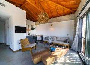 a living room with a couch and a table at Kikonia Art & Suites in Akyaka