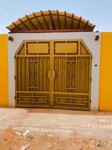 a large wooden garage door on a building at Cool meublé in Ouagadougou