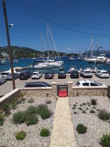 a parking lot with cars parked in a marina at Villa Don Kostangelo in Nikiana
