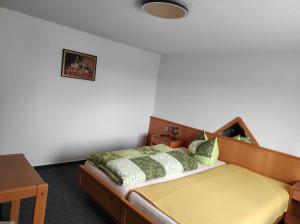 Gasthof Zur Goldenen Sonne في Remptendorf: غرفة نوم بسرير وطاولة