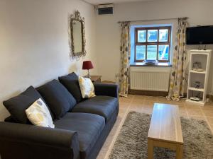 a living room with a couch and a table at Anroach Farm Peak District in Buxton