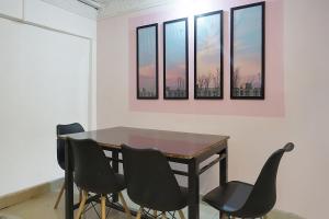 a dining room table with four chairs in a room at Collection O 83129 Hotel Galaxy Hospitality in Kharadi