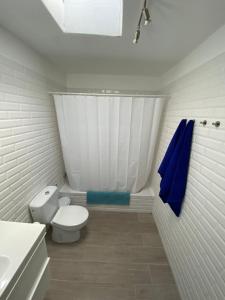 a bathroom with a toilet and a shower curtain at Playa Honda primera línea in Playa Honda +11 photos