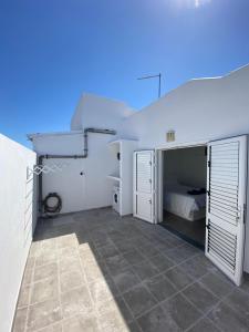 a bedroom with white doors and a bed at Playa Honda primera línea in Playa Honda
