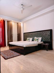 a bedroom with a large bed in a room at Hostmystay- 3Bhk Terrace! Gk1 M block in New Delhi +21 photos