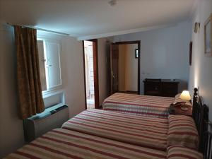 Postel nebo postele na pokoji v ubytování Hostal San Cayetano