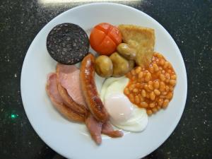 a plate of breakfast food with eggs bacon beans and toast at The Cliffbury in Llandudno