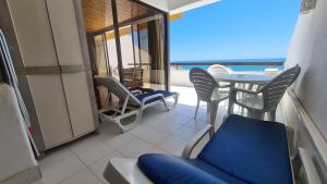a room with a balcony with a table and chairs at Albufeira Sea view (51) in Albufeira