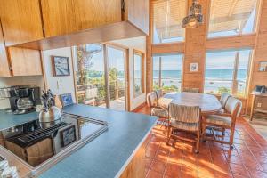 a kitchen and dining room with a table and chairs at RidgeTop in Lincoln City
