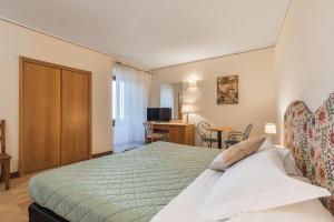 Postel nebo postele na pokoji v ubytování Relais La Fattoria