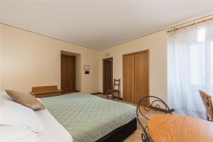 Postel nebo postele na pokoji v ubytování Relais La Fattoria