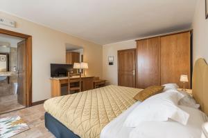 Postel nebo postele na pokoji v ubytování Relais La Fattoria
