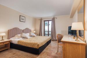 Postel nebo postele na pokoji v ubytování Relais La Fattoria