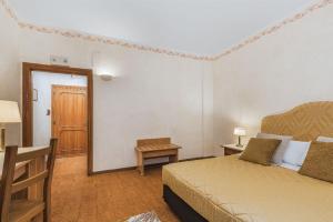 Postel nebo postele na pokoji v ubytování Relais La Fattoria