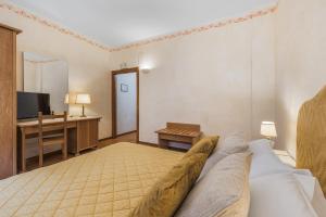 Postel nebo postele na pokoji v ubytování Relais La Fattoria