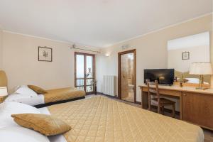 Postel nebo postele na pokoji v ubytování Relais La Fattoria