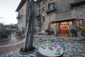 a table and chairs in front of a building at Relais La Fattoria in Castel Rigone