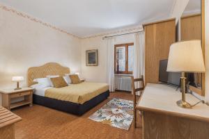 Postel nebo postele na pokoji v ubytování Relais La Fattoria