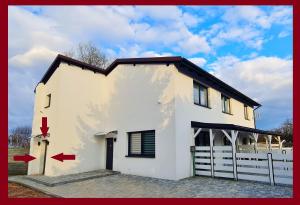 Una casa blanca con una flecha roja apuntándole. en Dream Apartments 3B KLIMATYZACJA, en Oświęcim