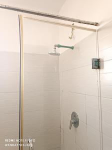 een douche met een glazen deur in de badkamer bij Furnished ensuite rooms behind City mall in Mombasa