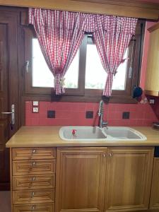 a kitchen with a sink and a window at Villa Manolia in Krikellos