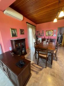 a dining room with a table and chairs in it at Villa Manolia in Krikellos