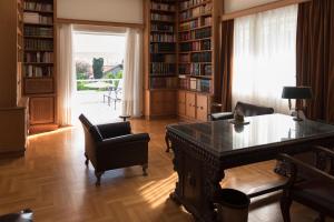 un ufficio con una scrivania e sedie in una biblioteca di Pelion's Finest Estate a Káto Lekhónia