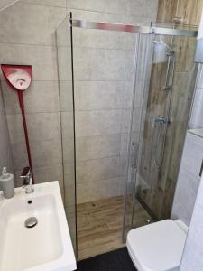 a bathroom with a shower and a sink at LIGHTHOUSE - Adults Only - 12Plus in Krynica Morska