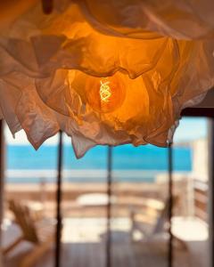 a view of the ocean from a window of a beach at Hotel Plein Large in Bandol