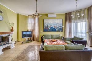 a living room with a couch and a tv at The view villa in Petrovac na Moru +20 photos