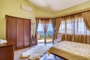 a bedroom with a bed and a large window at The view villa in Petrovac na Moru
