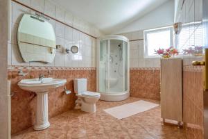 a bathroom with a sink and a toilet and a shower at The view villa in Petrovac na Moru