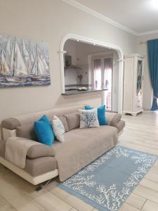 a living room with a couch and a mirror at Luxury Beach House in Torvaianica