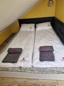 a bed with two pillows on top of it at LIGHTHOUSE - Adults Only - 12Plus in Krynica Morska