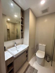 a bathroom with a sink and a toilet at Laguna Sky park in Laguna Phuket