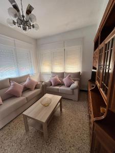 a living room with a couch and a table at CASA DE LA NIÑA,Chalet familiar con gran terraza in Fisterra