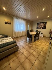 1 dormitorio con mesa, sillas y 1 cama en Tulum Ferienwohnung, en Rodenbach