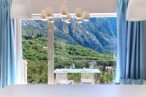 Cette chambre dispose d'une table et offre une vue sur la montagne. dans l'établissement GH Aparts with SCENIC VIEWS & POOL, à Gornji Orahovac 31 autres photos