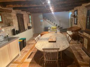 a kitchen with a large wooden table and chairs at Demeure de Charme La Source in Cestayrols
