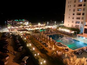 a large swimming pool in a parking lot at night at Apartment Ermest ,Kavaje Rock in Durrës