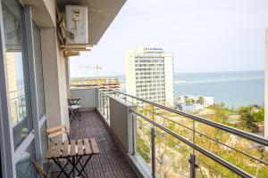 a balcony with a bench and a view of the ocean at Olimp 35 in Olimp
