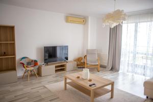 a living room with a tv and a coffee table at Olimp 35 in Olimp