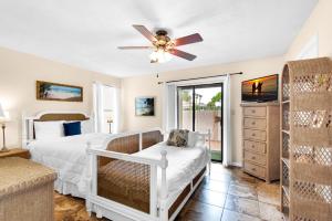 a bedroom with a bed and a ceiling fan at Beach Side- Harbor View in Destin