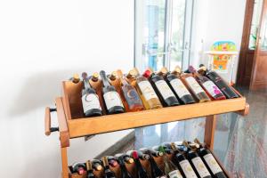 a bunch of bottles of wine on a shelf at Hotel Poseidon in Diamante