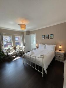 a bedroom with a large bed and a living room at Large East Side Room above G Grace & Son in Tring