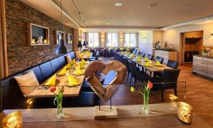 a restaurant with long tables with a heart on it at Landhotel Ewerts in Insul